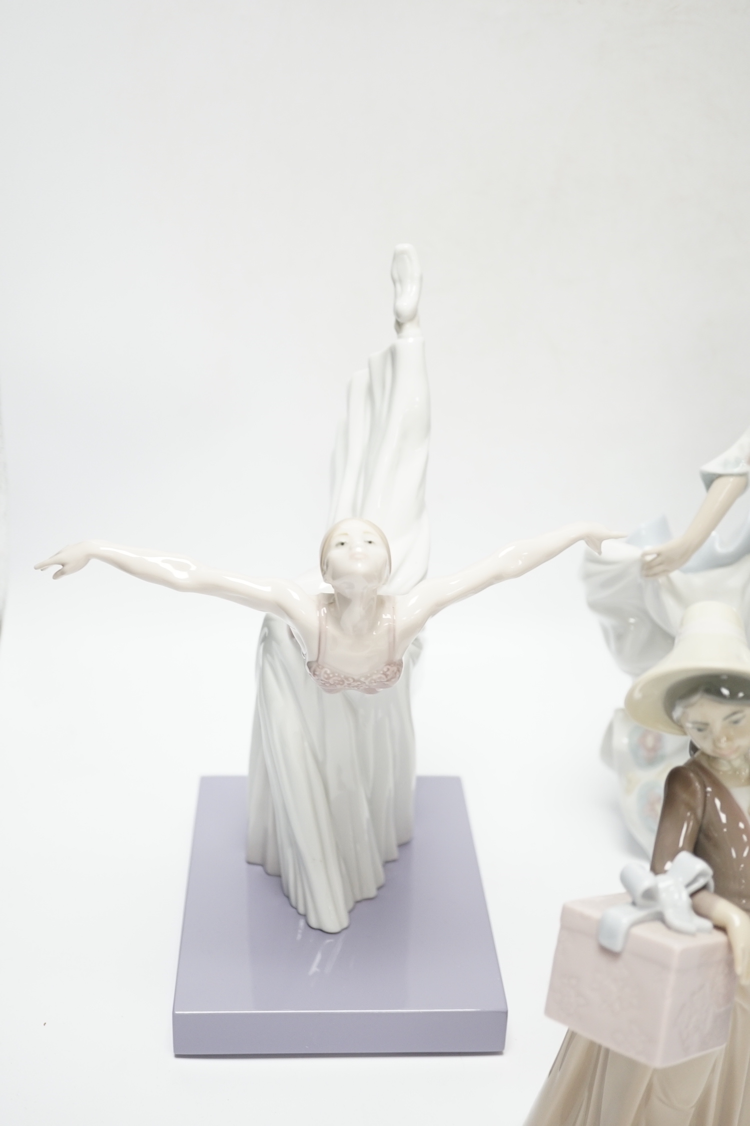 Four Lladro figurines; Reverie Moment, a model of a Ballet Dancer, and three other figurines (only two boxed)